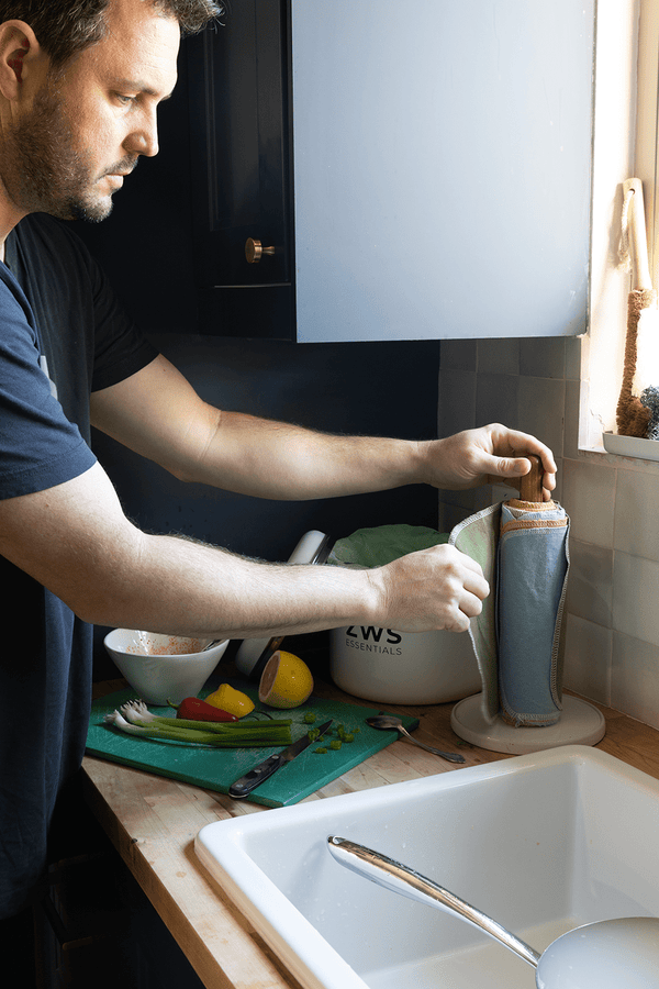 Pulling a Reusable Paper Towel from the holder by the kitchen sink
