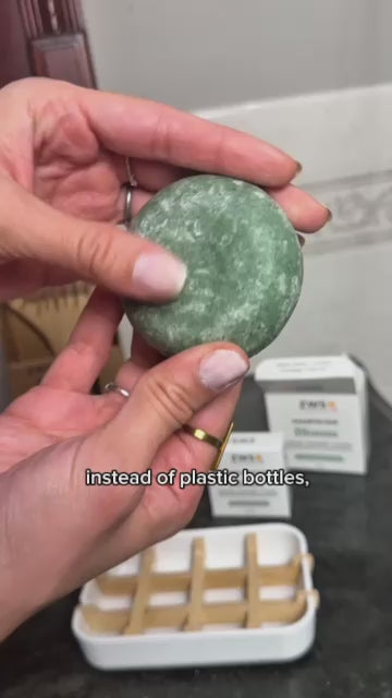 Creator clip: Caitlin lathers the shampoo bar through curly hair in the shower