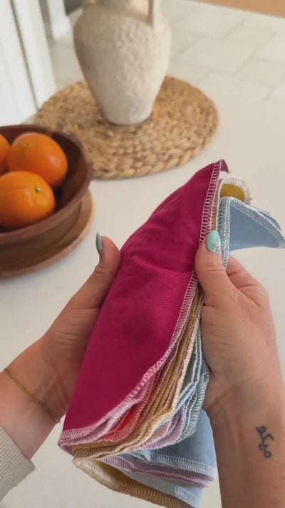 Flipping through a stack of Earth Tones Reusable Paper Towels, then drying hands with one at the sink