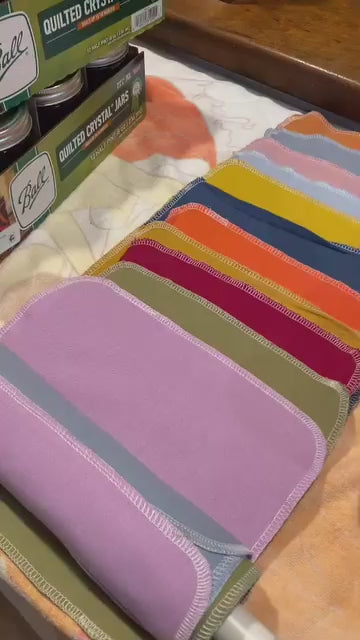 Re-rolling a rainbow set of Reusable Paper Towels onto a cardboard tube