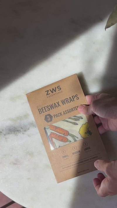 Opening a ZWS Essentials Beeswax Wraps pack and folding the first wrap