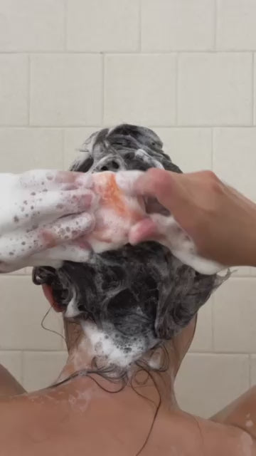 Creator clip: lathering the shampoo bar in the shower