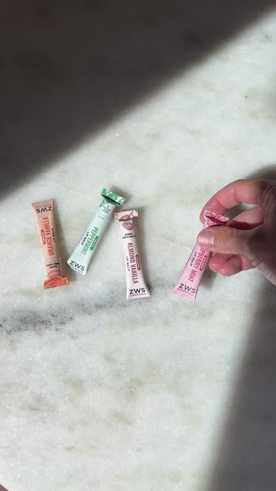 All five All Natural Lip Balm flavors in compostable paper tubes
