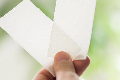 holding two halves of a laundry detergent sheet