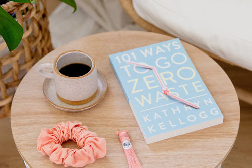 a small coffee cup and saucer, a book titled