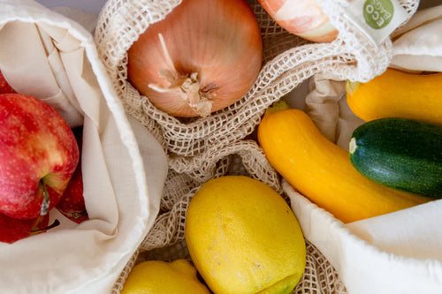 reusable muslin and mesh bags containing fruits and vegetables